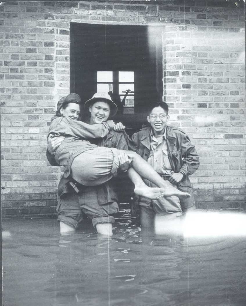 Betty McIntosh being carried by fellow OSS officers during a flood in WWII